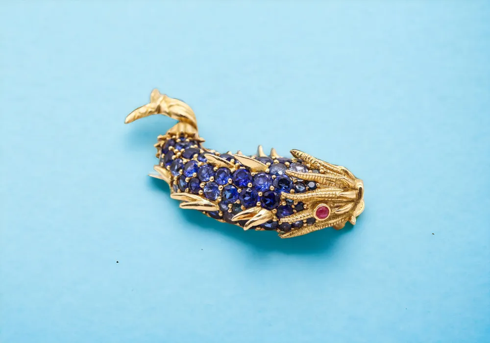 A gold koi fish brooch.