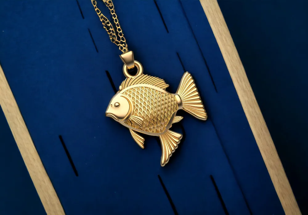 A gold fish pendant on a blue background.