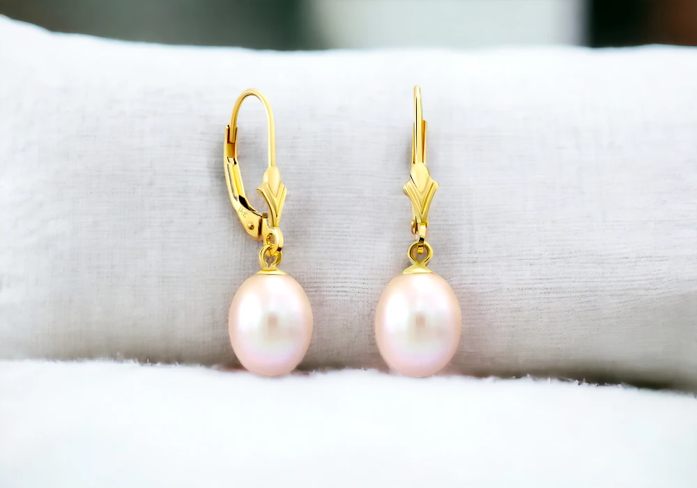 A pair of pink gemstone earrings on a white surface.